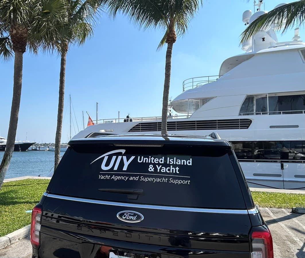UIY-branded Ford Expedition at a Palm Beach marina alongside a superyacht