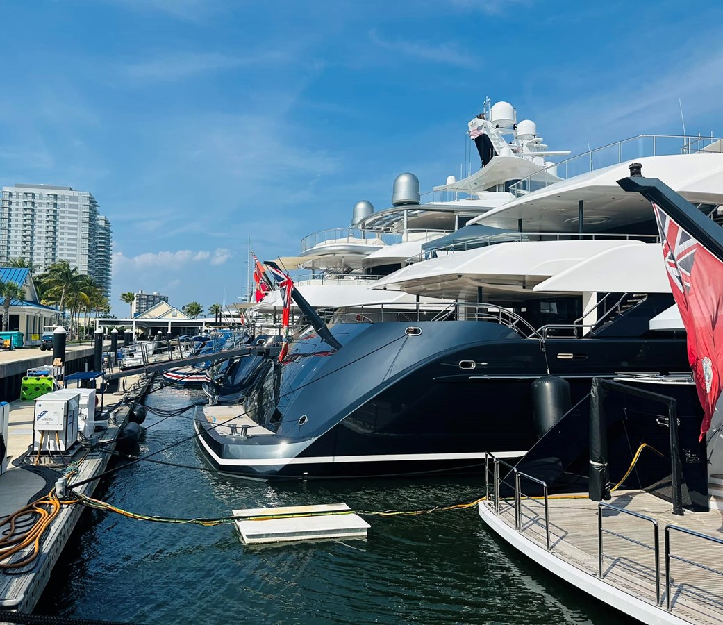 Superyachts berthed at a UIY-served marina under blue skies